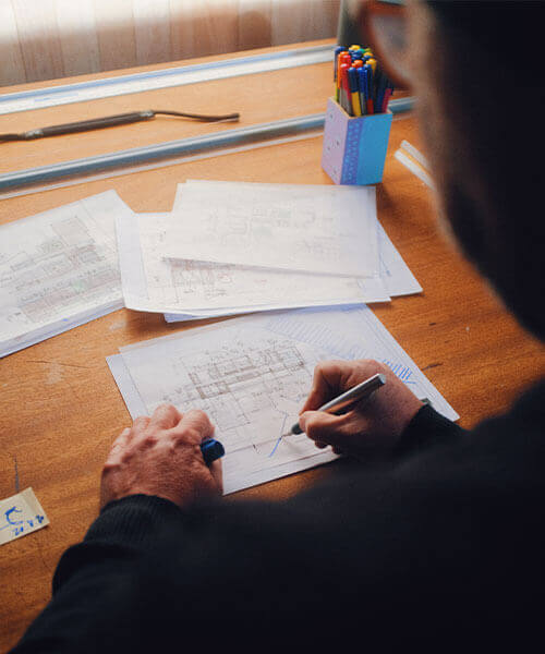 Male architect evaluating building plans