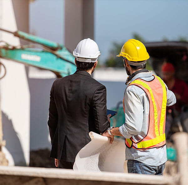 Surveyor on site working with foreman